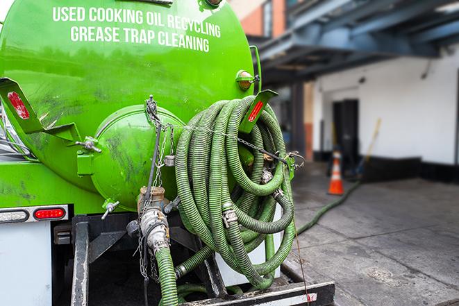 large truck pumping grease trap at a restaurant in Jamesport